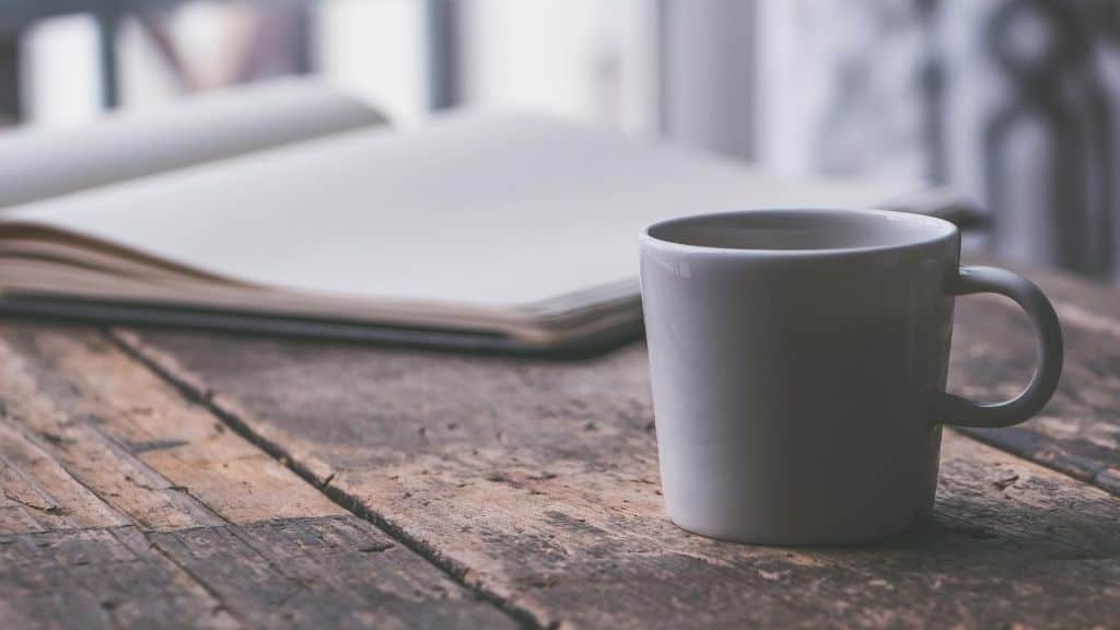 coffee break mug and notebook on table