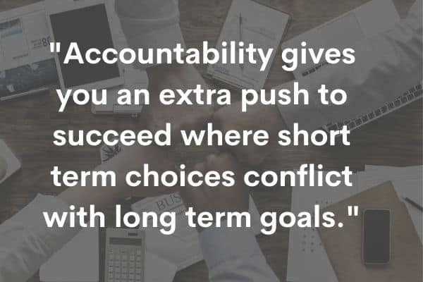 accountability quote with hands over office desk