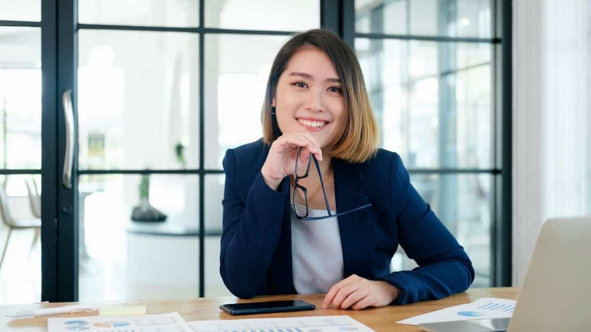 confident woman with glasses in office