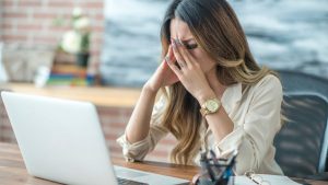 woman at desk stressed out at work