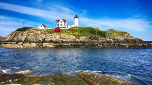 white lighthouse on island in New England