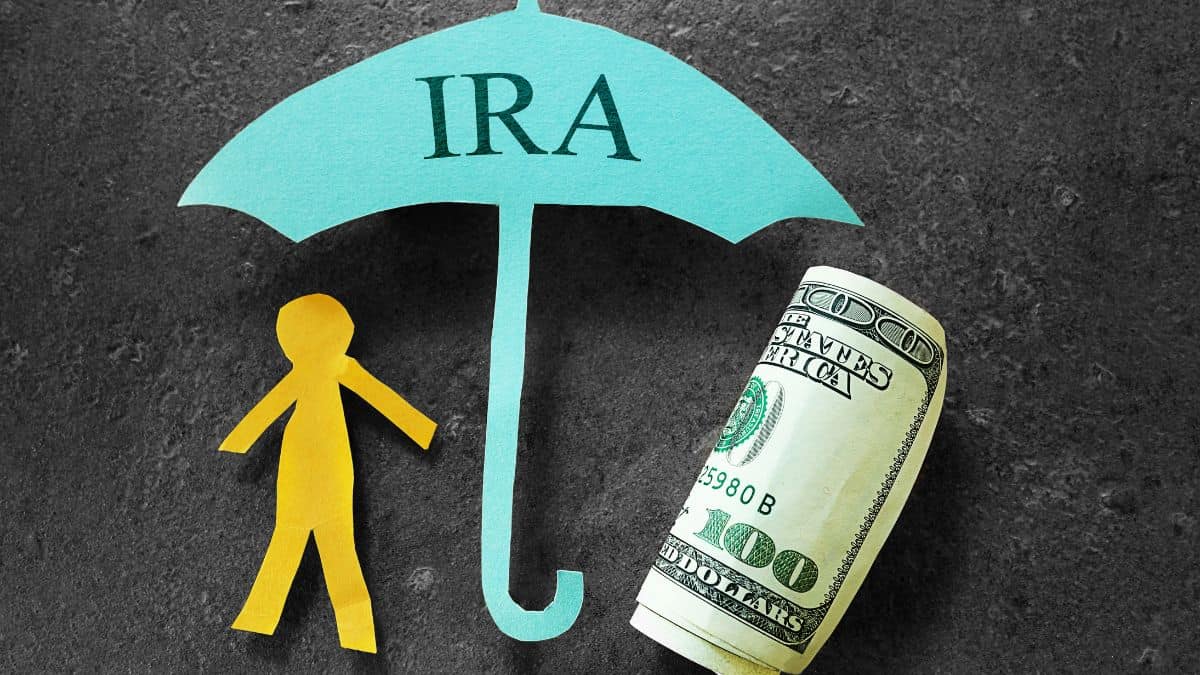 IRA umbrella shielding yellow paper person and cash