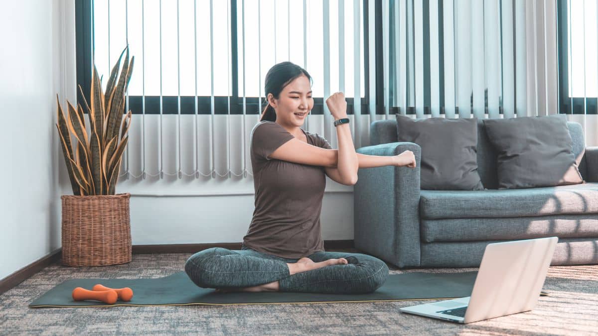 woman doing exercise routine on floor in front of couch